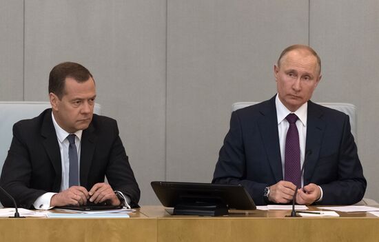 Russian President Vladimir Putin and candidate for Prime Minister Dmitry Medvedev attend State Duma plenary meeting