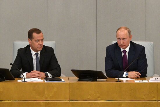 Russian President Vladimir Putin and candidate for Prime Minister Dmitry Medvedev attend State Duma plenary meeting