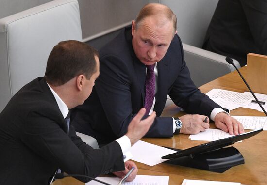Russian President Vladimir Putin and candidate for Prime Minister Dmitry Medvedev attend State Duma plenary meeting