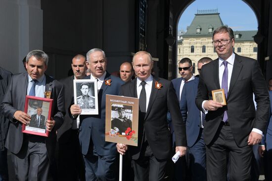 Russian President Vladimir Putin takes part in Immortal Regiment event