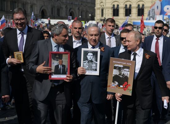Russian President Vladimir Putin takes part in Immortal Regiment event