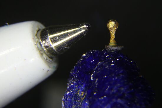 Craftsman from Novosibirsk carves copy of World Cup trophy on poppy seed