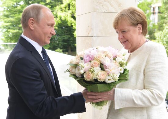 President Vladimir Putin meets with German Chancellor Angela Merkel