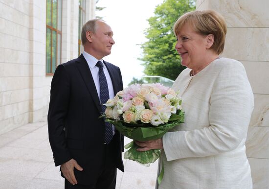 President Vladimir Putin meets with German Chancellor Angela Merkel