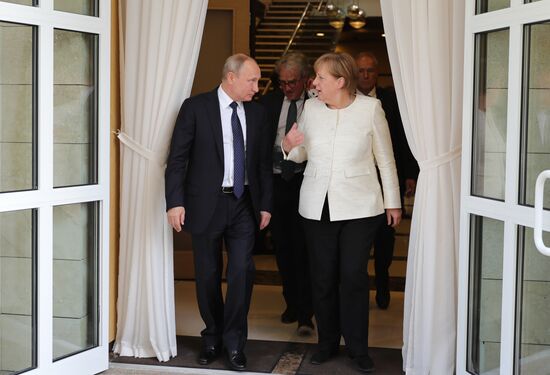 President Vladimir Putin meets with German Chancellor Angela Merkel