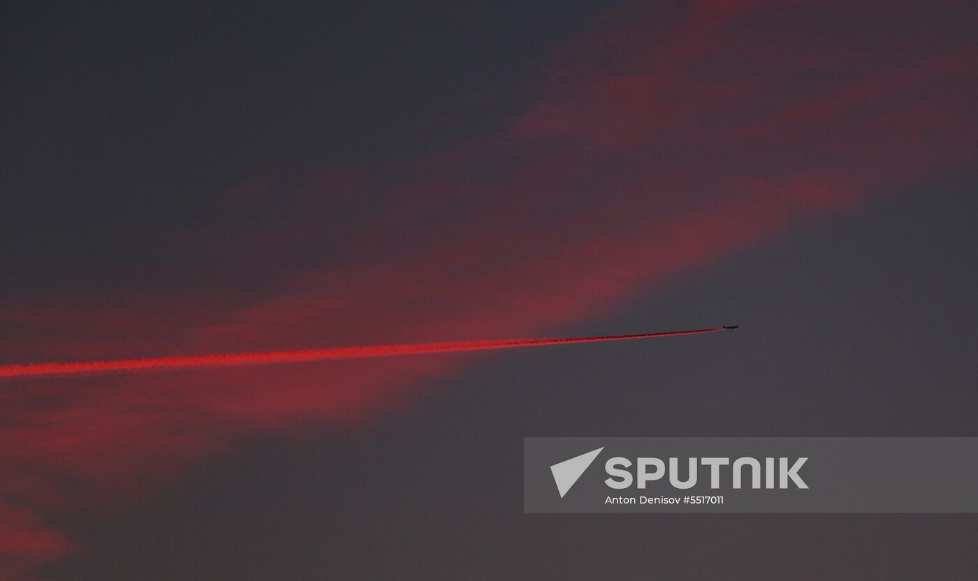 Airplane flight at sunset