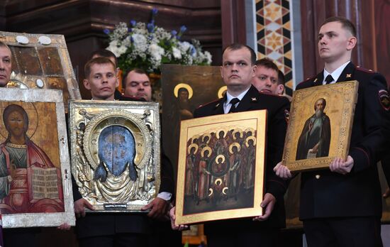 Russian Minister of Internal Affairs Vladimir Kolokoltsev passes ancient icons to Patriarch Kirill