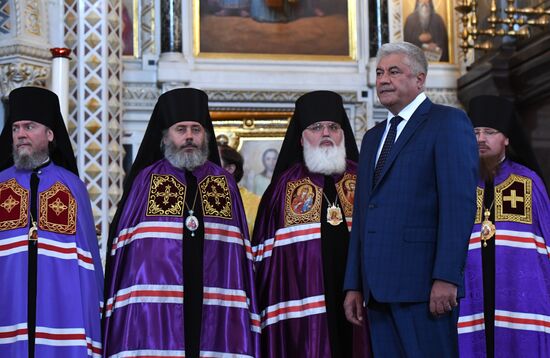 Russian Minister of Internal Affairs Vladimir Kolokoltsev passes ancient icons to Patriarch Kirill