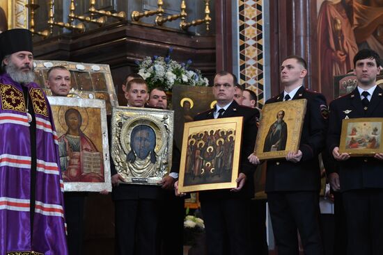 Russian Minister of Internal Affairs Vladimir Kolokoltsev passes ancient icons to Patriarch Kirill