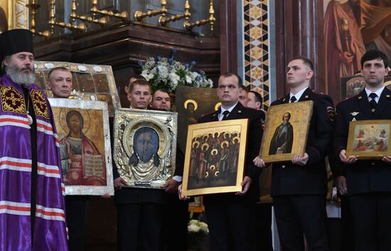 Russian Minister of Internal Affairs Vladimir Kolokoltsev passes ancient icons to Patriarch Kirill