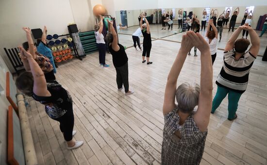 Seniors exercise in a fitness center