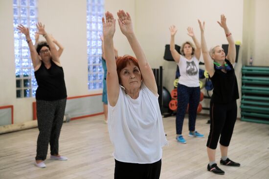 Seniors exercise in a fitness center