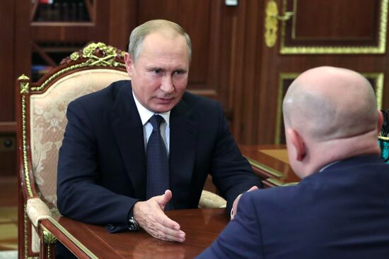 President Vladimir Putin meets with Mikhail Razvozhayev