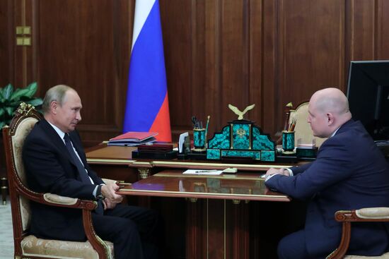 President Vladimir Putin meets with Mikhail Razvozhayev