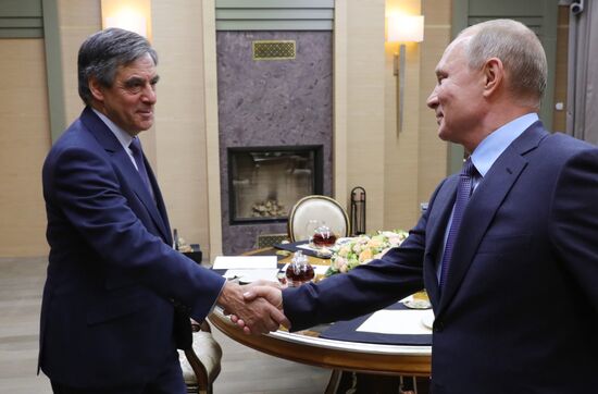 President Vladimir Putin meets with former French prime minister Francois Fillon