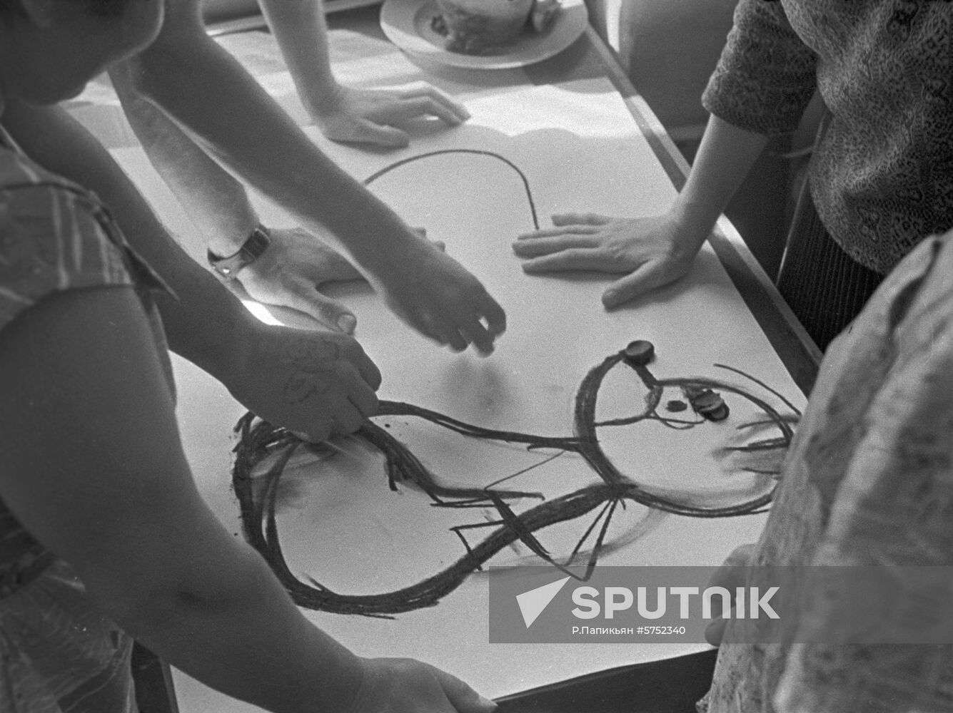 Artists draw sketch of wooden toy