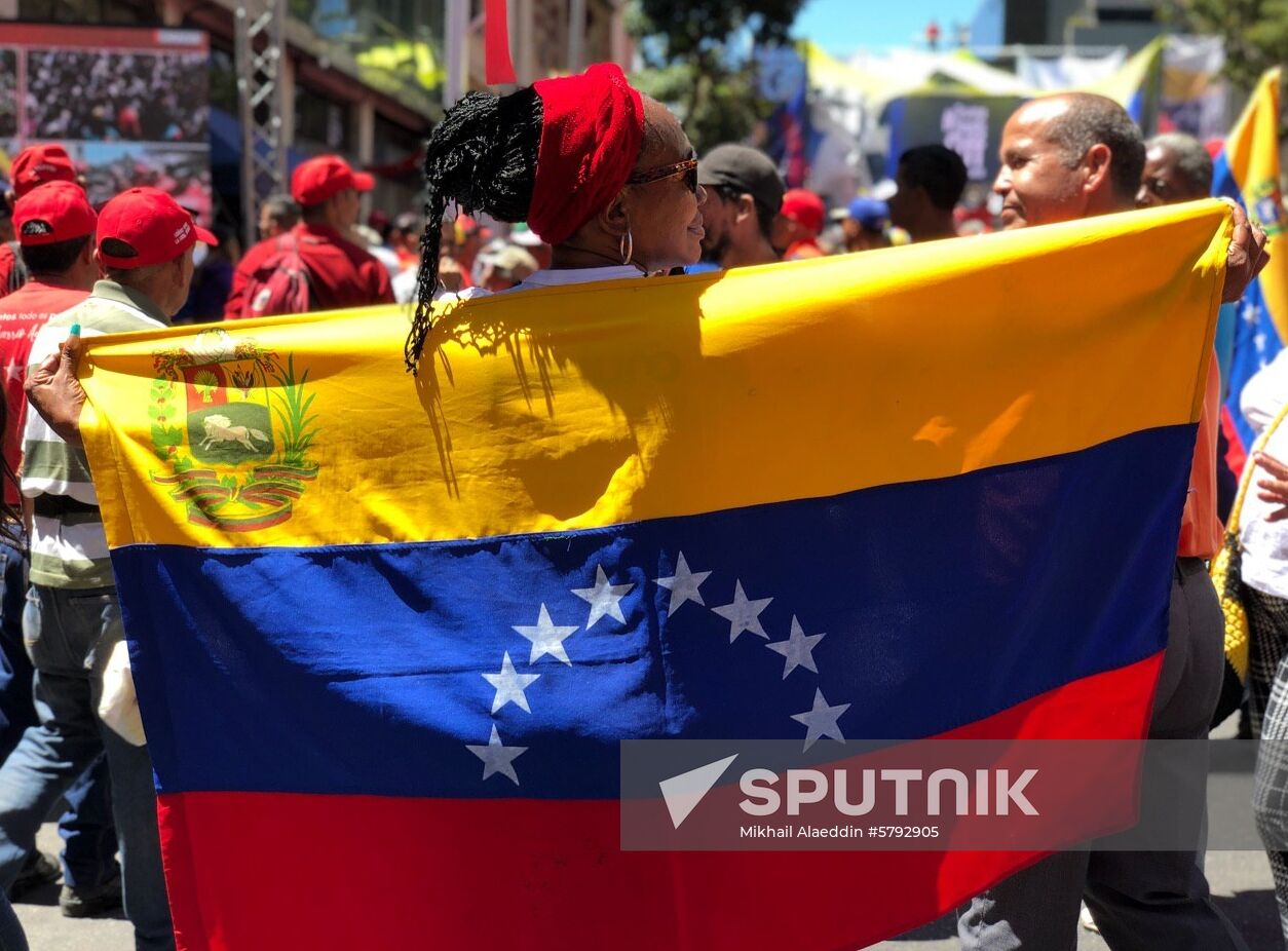 A supporter of Venezuelan President Nicolas Maduro holds a flag as she takes part in a rally, in Caracas, Venezuela. On January 22, the opposition-run Venezuelan National Assembly adopted a statement declaring President Maduro a usurper. On January 23, Venezuelan opposition leader Juan Guaido declared himself the country's Interim President at a mass rally in Caracas, and U.S. President Donald Trump has recognized Guaido as Venezuela's Interim President. Location: Venezuela, Caracas. Author: Mikhail Alaeddin/Sputnik. Venezuela Maduro Supporters