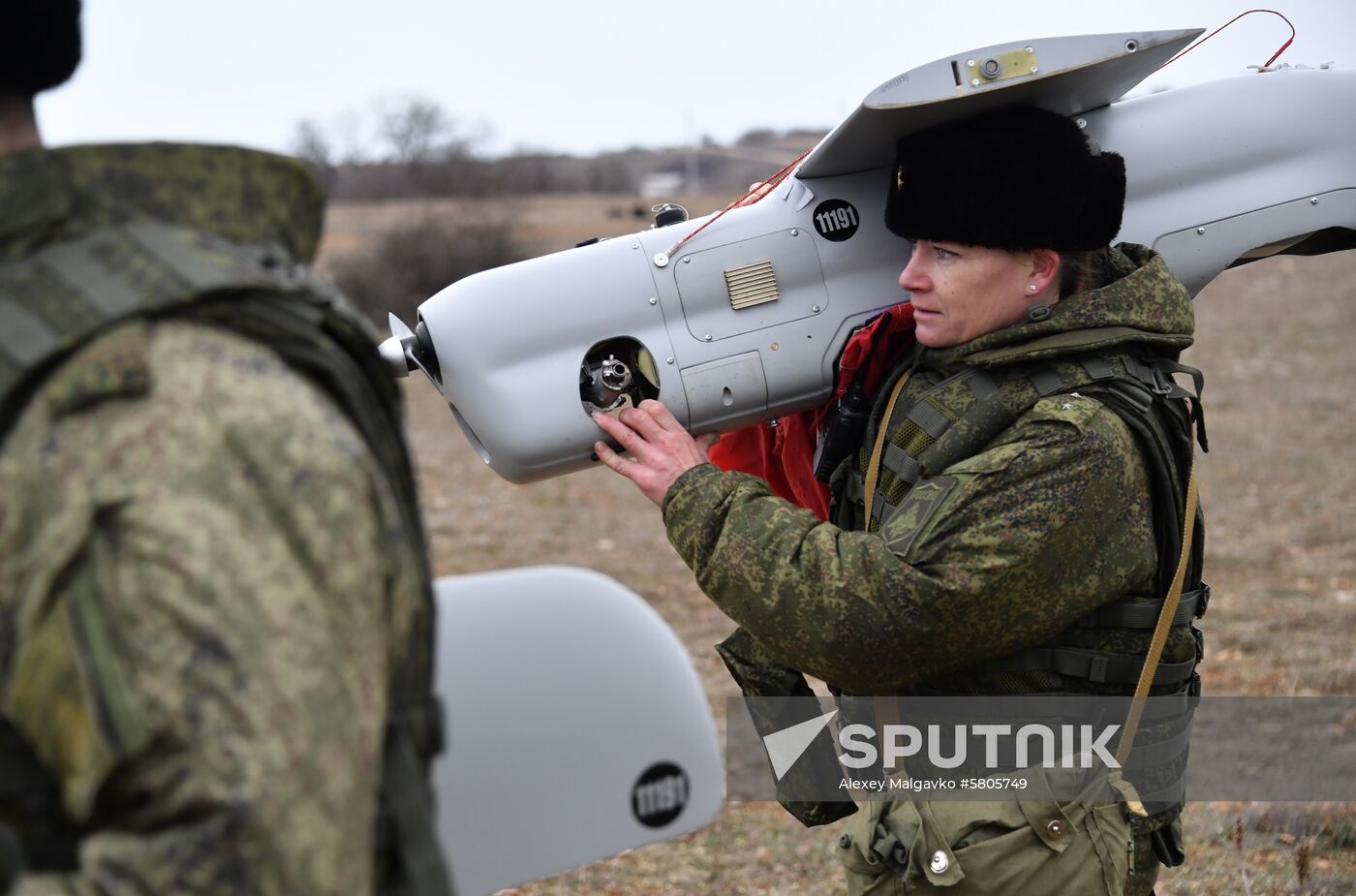 A Russian Black Sea Fleet reconnaissance brigade servicewoman carries a drone after its landing during a drills outside Sevastopol, Crimea, Russia. Location: Russia, Sevastopol. Author: Alexey Malgavko/Sputnik. Russia Female Drone Operators
