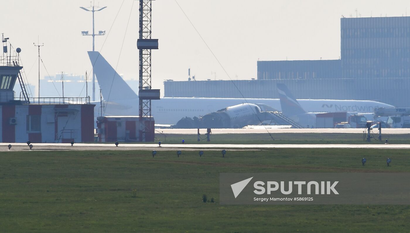 The hull of Aeroflot's Sukhoi Superjet 100 passenger plane, centre, is pictured at the Moscow’s Sheremetyevo International Airport, Russia. The fire aboard the jet broke out after the plane made a hard emergency landing. The plane had taken off from the airport bound for Murmansk, but turned back after encountering unspecified problems in the air. Location: Russia, Moscow. Author: Sergey Mamontov/Sputnik. Russia Plane Fire