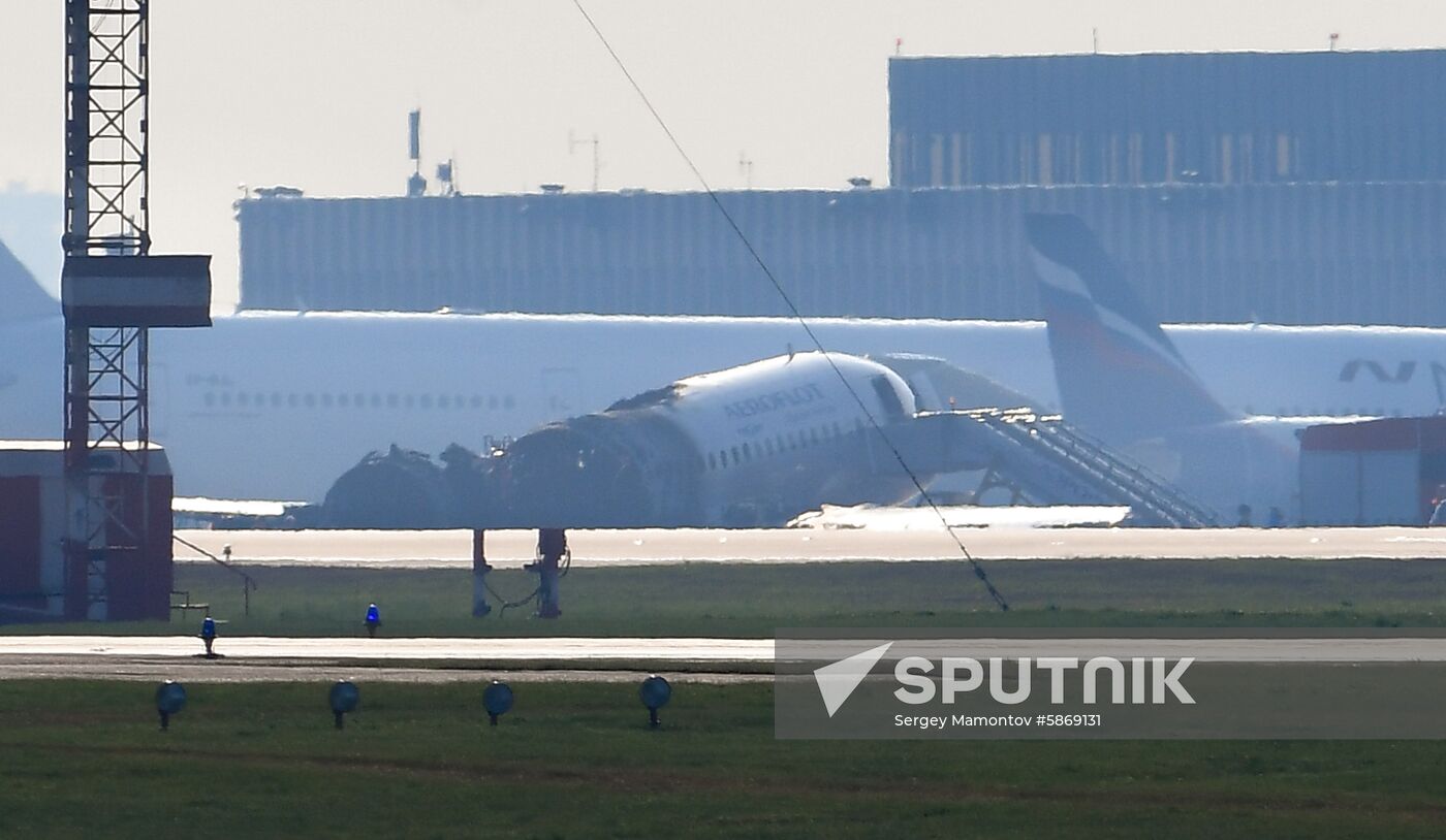 The hull of Aeroflot's Sukhoi Superjet 100 passenger plane, centre, is pictured at the Moscow’s Sheremetyevo International Airport, Russia. The fire aboard the jet broke out after the plane made a hard emergency landing. The plane had taken off from the airport bound for Murmansk, but turned back after encountering unspecified problems in the air. Location: Russia, Moscow. Author: Sergey Mamontov/Sputnik. Russia Plane Fire