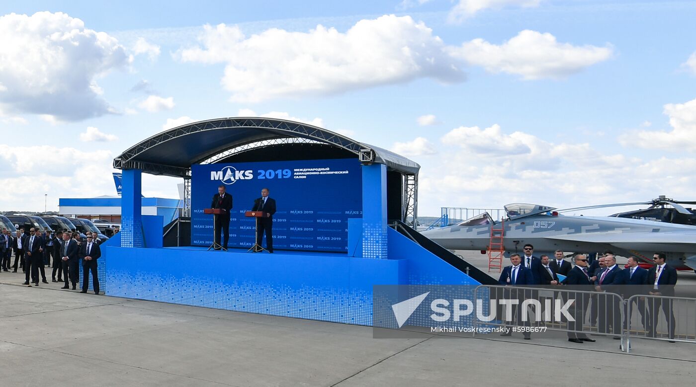 Russian President Vladimir Putin and his Turkish counterpart Recep Tayyip Erdogan, left, attend an opening ceremony at the MAKS-2019 international aviation and space show in Zhukovsky, outside Moscow, Russia. A 5th generation Sukhoi Su-57 fighter jet is at right. Location: Russia, Zhukovsky. Author: Mikhail Voskresenskiy/Sputnik. Russia MAKS Air Show Putin Erdogan