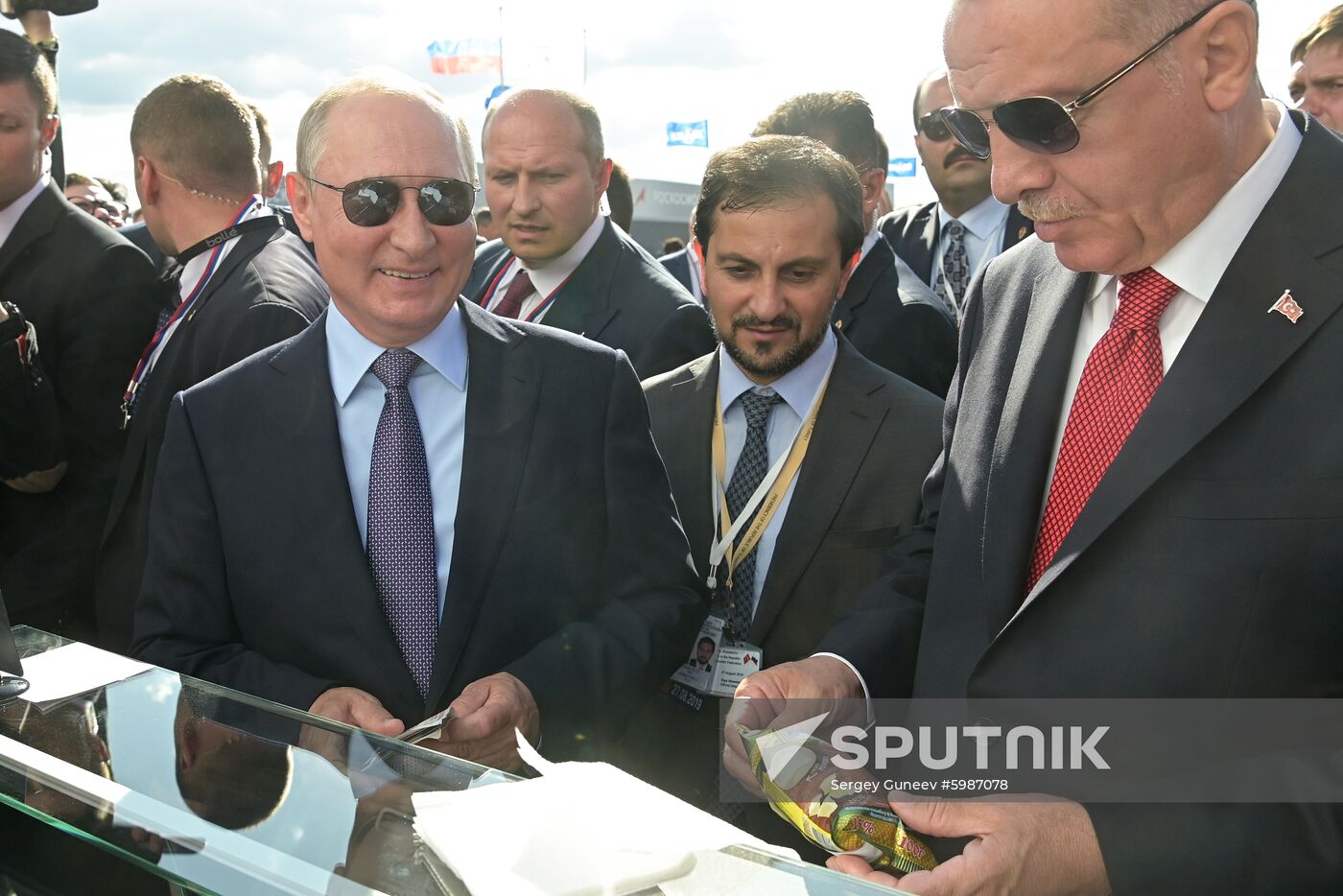 Russian President Vladimir Putin buys ice cream at the MAKS-2019 international aviation and space show in Zhukovsky, outside Moscow, Russia. Turkish President Recep Tayyip Erdogan is at right. Location: Russia, Zhukovsky. Author: Sergey Guneev/Sputnik. Russia MAKS Air Show Putin Erdogan