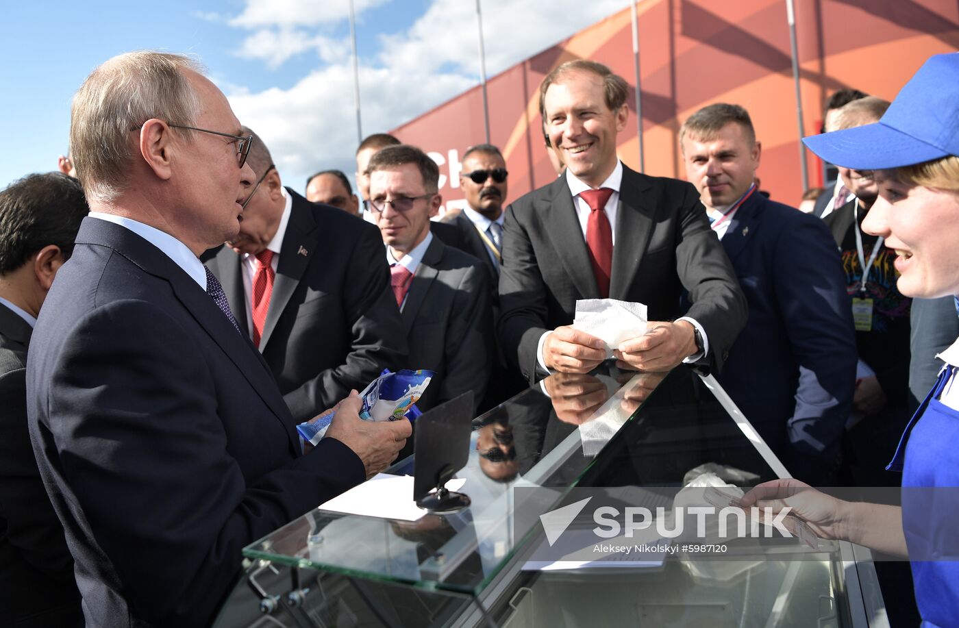 Russian President Vladimir Putin speaks with Industry and Trade Minister Denis Manturov as he buys ice cream during a visit to the MAKS-2019 International Aviation and Space Show in Zhukovsky, outside Moscow, Russia. Location: Russia, Moscow region, Zhukovsky. Author: Aleksey Nikolskyi/Sputnik. Russia MAKS Air Show Putin Erdogan