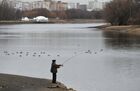A man fishes in Kolomenskoye park on a warm winter day, in Moscow, Russia. Location: Russia, Moscow. Author: Maksim Blinov/Sputnik. Russia Warm Weather