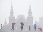People walk during snowfall in Red Square, in downtown Moscow, Russia. Location: Russia, Moscow. Author: Evgeny Biyatov/Sputnik. Russia Winter