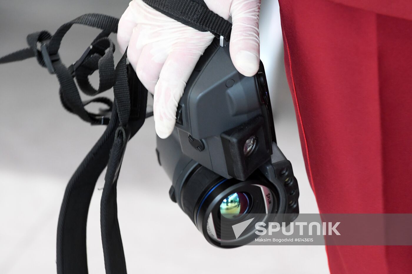 A worker of quarantine and sanitary station holds a thermovision display device to check the temperature of passengers at an airport, in Kazan, Russia's Republic of Tatarstan. Russian airports have stepped up screening of travelers arriving from China to try to identify people infected with the new coronavirus. An outbreak of a new coronavirus that began in the central Chinese city of Wuhan has killed 17 and infected nearly 600 people globally. Location: Russia, Republic of Tatarstan, Kazan. Author: Maksim Bogodvid/Sputnik. Russia New Coronavirus