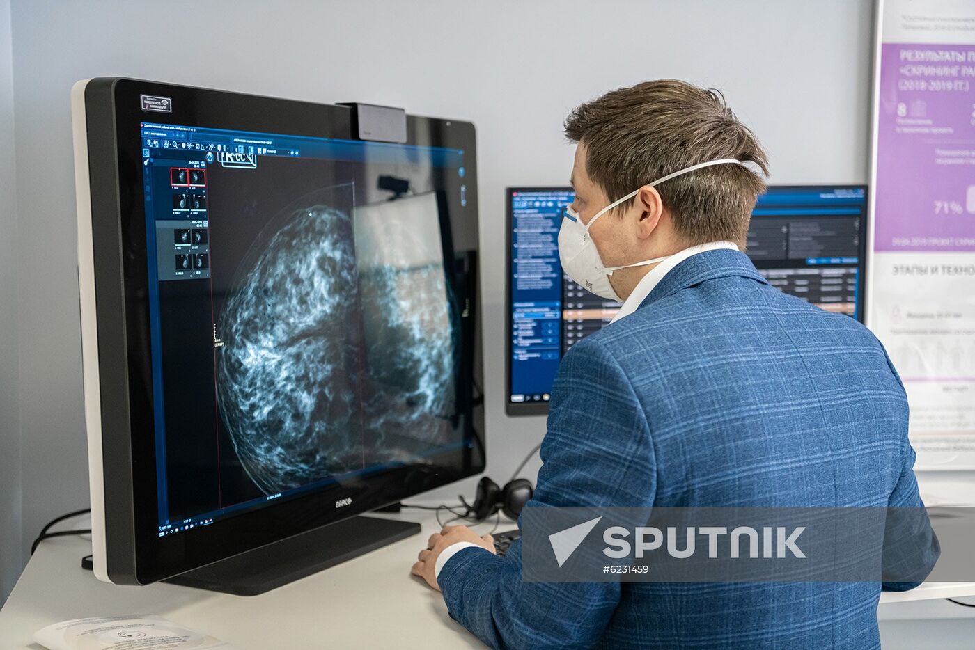 In this handout photo released by Press Service of Moscow Mayor and the Moscow Government, an employee of the Moscow reference center for radiation diagnostics, where they are launching a "computer vision" system, in Moscow, Russia. The Moscow reference center for radiation diagnostics is beginning to use artificial intelligence technologies to recognize signs of coronavirus infection on CT scans of the lungs. Editorial use only, no archive, no commercial use. Location: Russia, Moscow. Russia Coronavirus Hospital Facilities