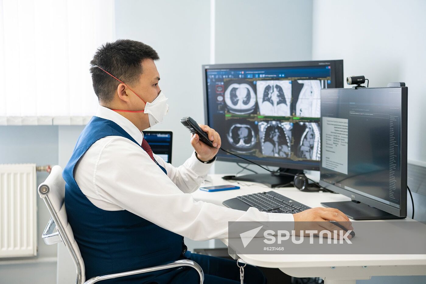 In this handout photo released by Press Service of Moscow Mayor and the Moscow Government, an employee of the Moscow reference center for radiation diagnostics, where they are launching a "computer vision" system, in Moscow, Russia. The Moscow reference center for radiation diagnostics is beginning to use artificial intelligence technologies to recognize signs of coronavirus infection on CT scans of the lungs. Editorial use only, no archive, no commercial use. Location: Russia, Moscow. Russia Coronavirus Hospital Facilities