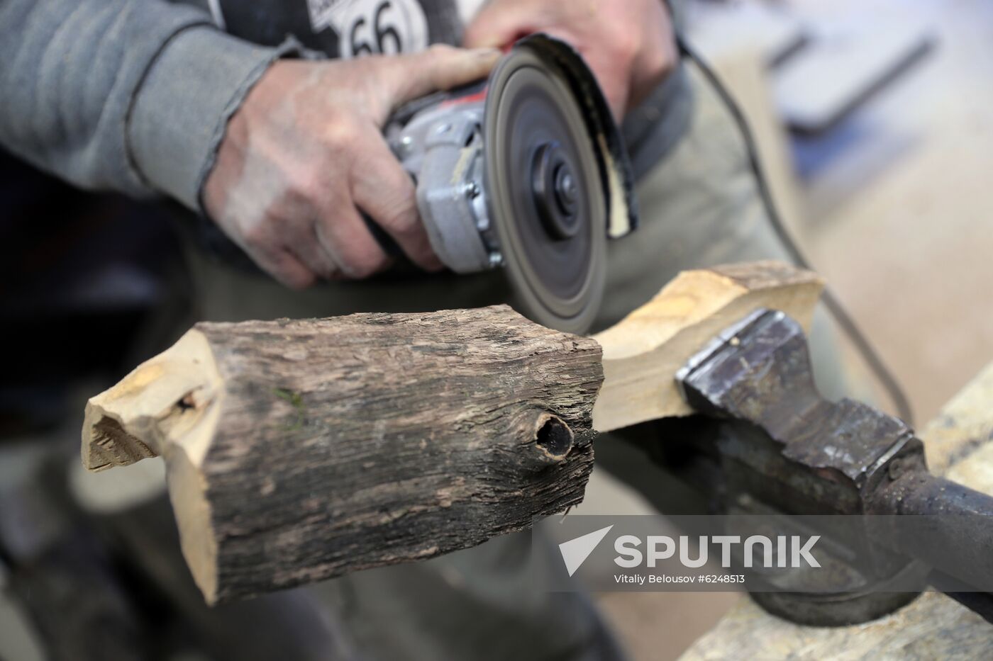Wood carver Andrei Pisarev works during self-isolation at his country house
