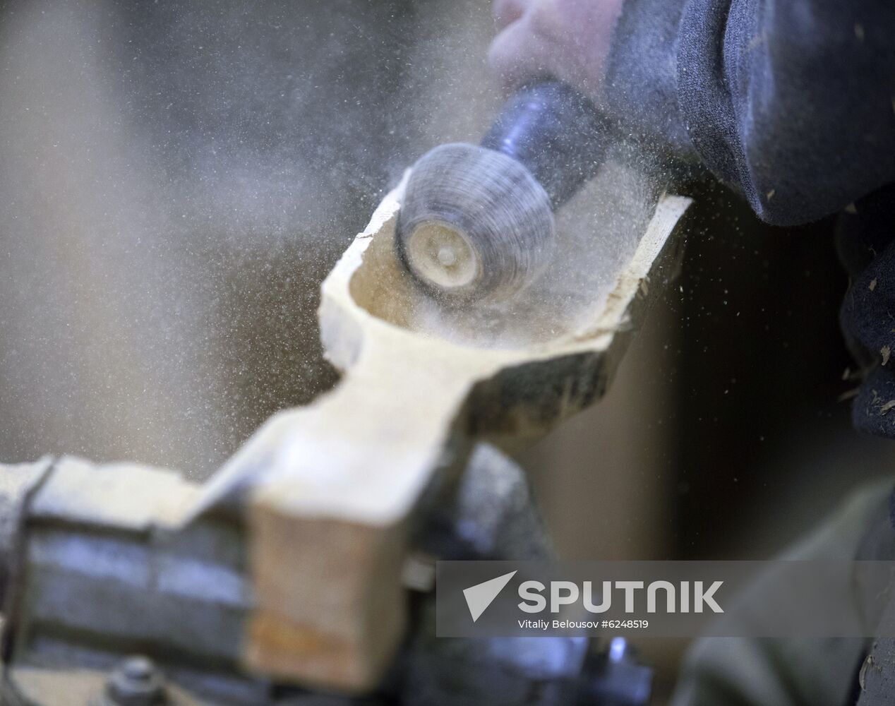 Wood carver Andrei Pisarev works during self-isolation at his country house