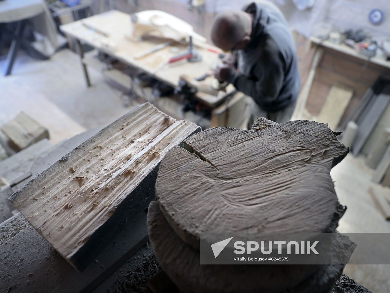 Wood carver Andrei Pisarev works during self-isolation at his country house