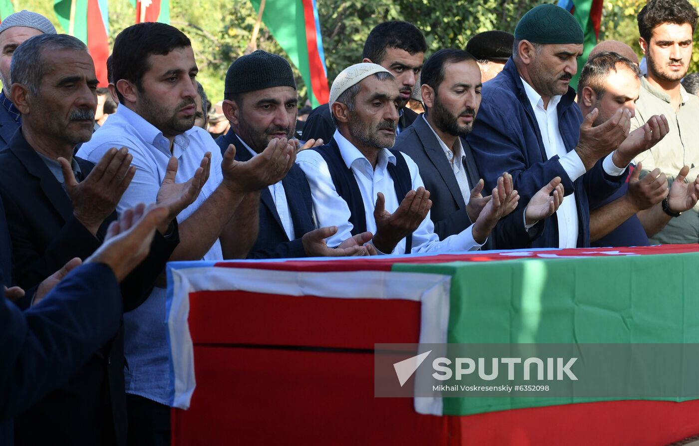 Men pray during a funeral ceremony for a serviceman who died in action, in a village near the combat zone, in Azerbaijan. A fresh spark in the conflict between Armenia and Azerbaijan in the disputed Nagorno-Karabakh region occurred on September, 27. Yerevan and Baku both accused each other of violating the 1994 ceasefire and causing civilian casualties. Location: Azerbaijan. Author: Mikhail Voskresenskiy/Sputnik. Azerbaijan Armenia Escalation