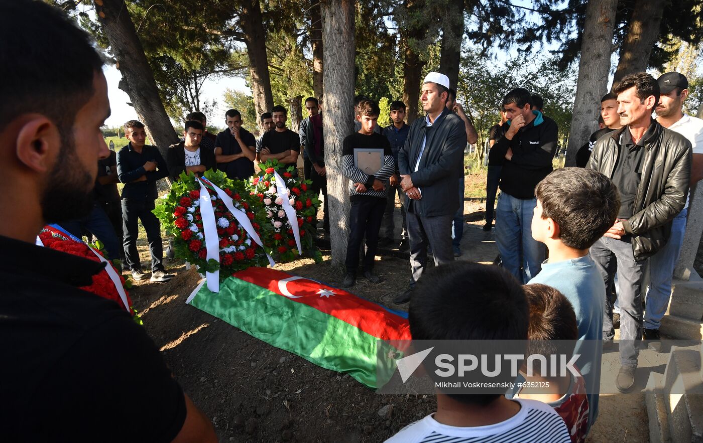 People pray during a funeral ceremony for a serviceman who died in action, in a village near the combat zone, in Azerbaijan. A fresh spark in the conflict between Armenia and Azerbaijan in the disputed Nagorno-Karabakh region occurred on September, 27. Yerevan and Baku both accused each other of violating the 1994 ceasefire and causing civilian casualties. Location: Azerbaijan. Author: Mikhail Voskresenskiy/Sputnik. Azerbaijan Armenia Escalation