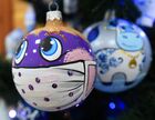 A glass Christmas and New Year tree decoration with coronavirus face mask pattern is seen at the "Biryusinka" toy factory, which has been producing decorations and toys for the festive season since 1942, in the Siberian city of Krasnoyarsk, Russia. Location: Russia, Krasnoyarsk. Author: Ilya Naymushin/Sputnik. Russia New Year Preparations