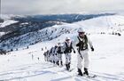 In this handout video grab released by Russian Defence Ministry, participants of the ski mountaineering competition Sayan March-2021 as part of the International Army Games take part in a flash mob in support of medics curing COVID-19, on the top of the Western Sayan Mountain, in Krasnoyarsk region, Russia. Ski-climbers unfurled a banner with words of gratitude to the medical workers treating coronavirus patients at an altitude of about 2 thousand meters. Editorial use only, no archive, no commercial use. Location: Russia, Krasnoyarsk region. Russia Coronavirus Military Climbers Flashmob