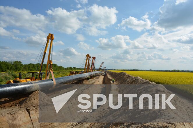 In this handout photo released by the press-service of Eugal, a view shows lowering of Eugal pipes, in Germany. The Eugal pipeline, which will receive gas from Nord Stream 2 in the future, has reached full pumping capacity, and the second line of the pipeline has been introduced. European gas pipeline link (EUGAL) is a 480km-long natural gas transport network being developed in order to strengthen the supply of natural gas to Germany and Europe. Editorial use only, no archive, no commercial use. Location: Germany. Germany Nord Stream Gas Pipeline