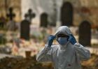 A man wearing a protective suit attends the burial of a person who died from the coronavirus disease, at a graveyard, in Delhi, India. Location: India, Delhi. Author: Idrees Mohammed/Sputnik. India Coronavirus