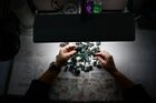 An employee cleans and cuts emeralds at the Mariinsky mine's emerald recovery factory, in Sverdlovsk Oblast region, Russia. Location: Russia, Sverdlovsk Oblast Region. Author: Pavel Lisitsyn. Russia Emeralds Mining