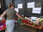 A woman lays flowers for Kazan school shooting victims outside the representative office of Russia's Republic of Tatarstan in Saint Petersburg, Russia. At least nine people, including seven children, were killed in the school shooting in Kazan, while 20 more people were hospitalized with injuries. A former student of the Gymnasium No. 175, 19-year-old male who started shooting at the educational institution was detained earlier in the day. Location: Russia, Saint Petersburg. Author: Alexander Galperin. Russia School Shooting