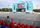 A man and a child watch a broadcasting of the Euro 2020 soccer match between Wales and Denmark at the Euro 2020 fan zone in Luzhniki in Moscow, Russia. The UEFA Euro 2020 fan zone has been opened only for those who can provide QR codes for verifying citizens' COVID-19 status, including vaccination history and PCR results, amid a sharp rise in new coronavirus cases in Moscow region. Location: Russia, Moscow. Author: Pavel Bednyakov/Sputnik. Russia Soccer Euro 2020 Coronavirus Restrictions