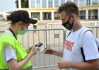 A man wearing a face mask shows a QR code for verifying his COVID-19 status at the entrance of the Euro 2020 fan zone in Luzhniki, in Moscow, Russia. A sign on the T-shirt reads "Vaccinated". The UEFA Euro 2020 fan zone has been opened only for those who can provide QR codes for verifying citizens' COVID-19 status, including vaccination history and PCR results, amid a sharp rise in new coronavirus cases in Moscow region. Location: Russia, Moscow. Author: Pavel Bednyakov/Sputnik. Russia Soccer Euro 2020 Coronavirus Restrictions