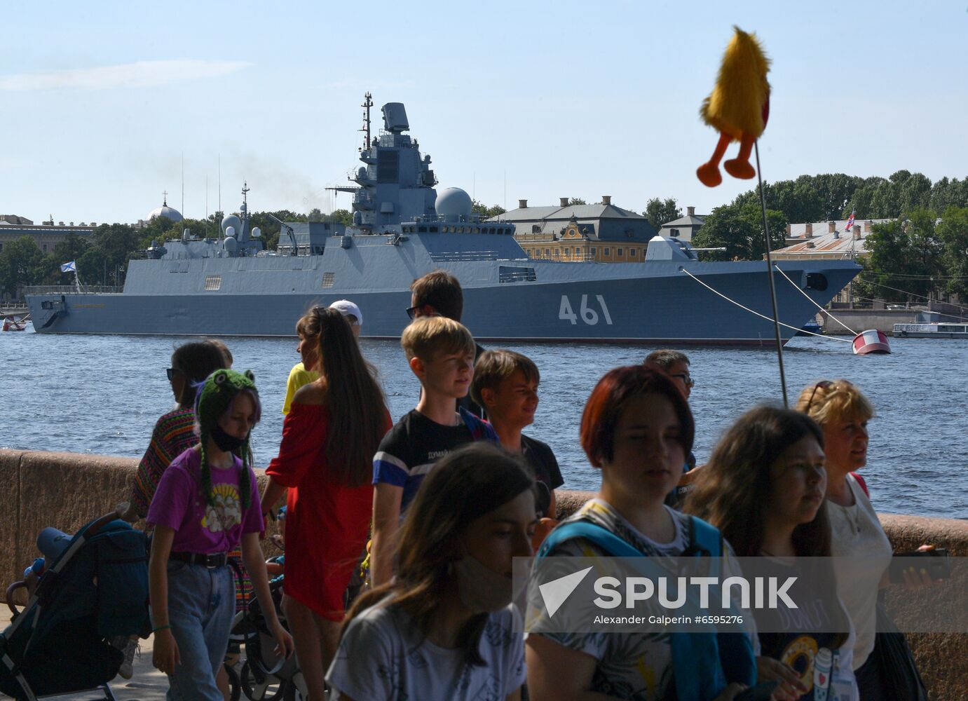 People walk along an embankment of the Neva river, with the Admiral Kasatonov Russian Navy frigate seen in the background, before the upcoming Russian Navy Day parade in St. Petersburg, Russia. Location: Russia, Saint Petersburg. Author: Alexander Galperin/Sputnik. Russia Navy Day Parade Rehearsal