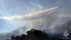 In this handout video grab released by the Russian Emergency Situations Ministry, a BE-200CHS plane extinguishes forest fires in Russia's Sakha Republic (Yakutia). Editorial use only, no archive, no commercial use. Location: Russia, Republic of Sakha (Yakutia). Russia Wildfires