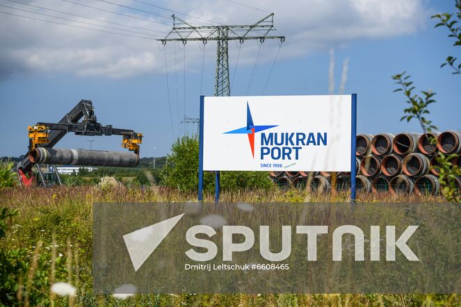 A tractor carries a pipe for the Nord Stream 2 Baltic Sea gas pipeline, at the port of Mukran on the Rugen island, in Mecklenburg-West Pomerania, Germany. Location: Germany. Author: Dmitrij Leltschuk/Sputnik. Germany Nord Stream Gas Pipeline