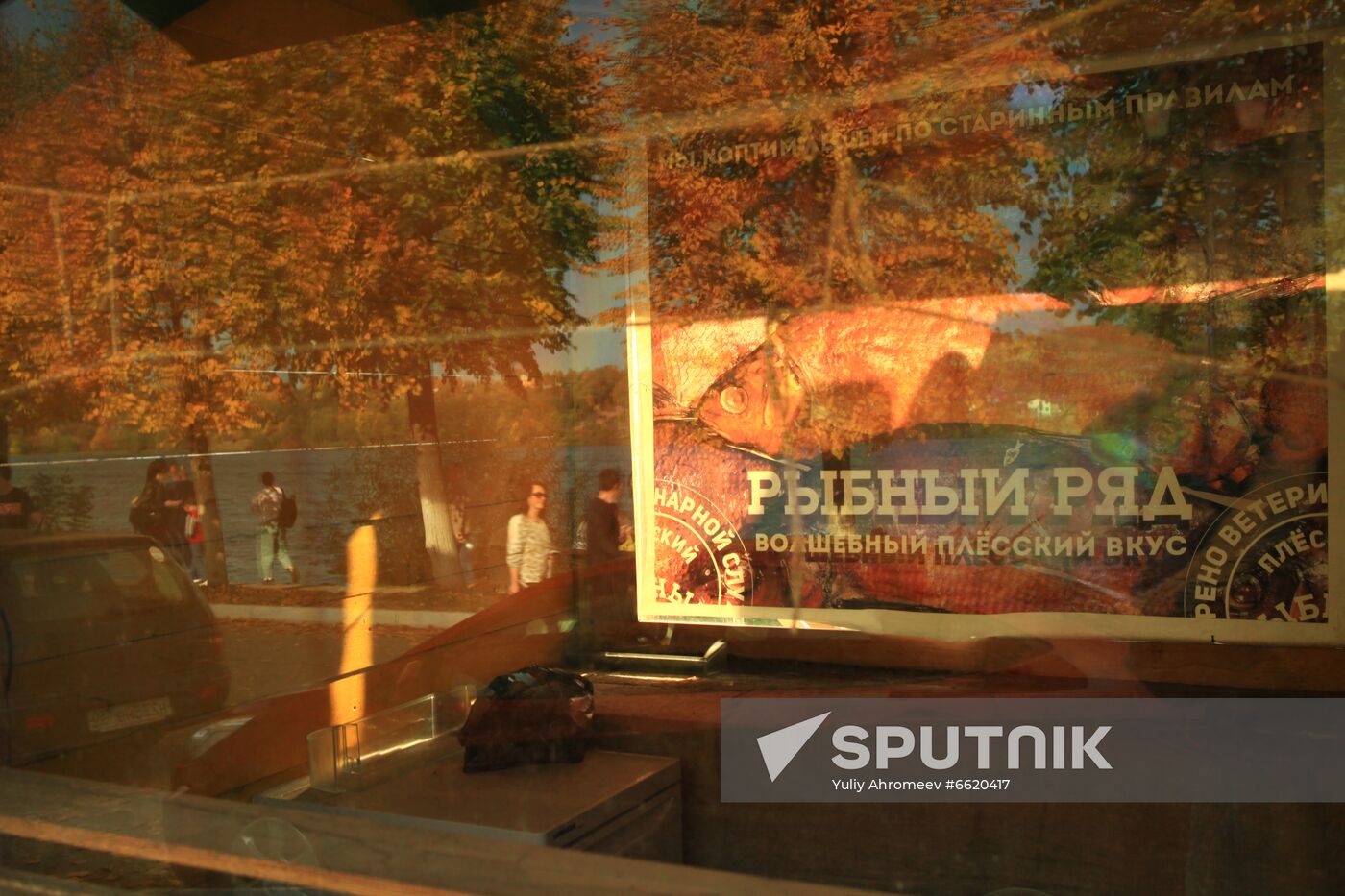 Embankment reflects in fish store's glass in Plyos