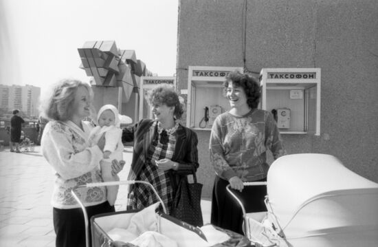 Young women walk with children